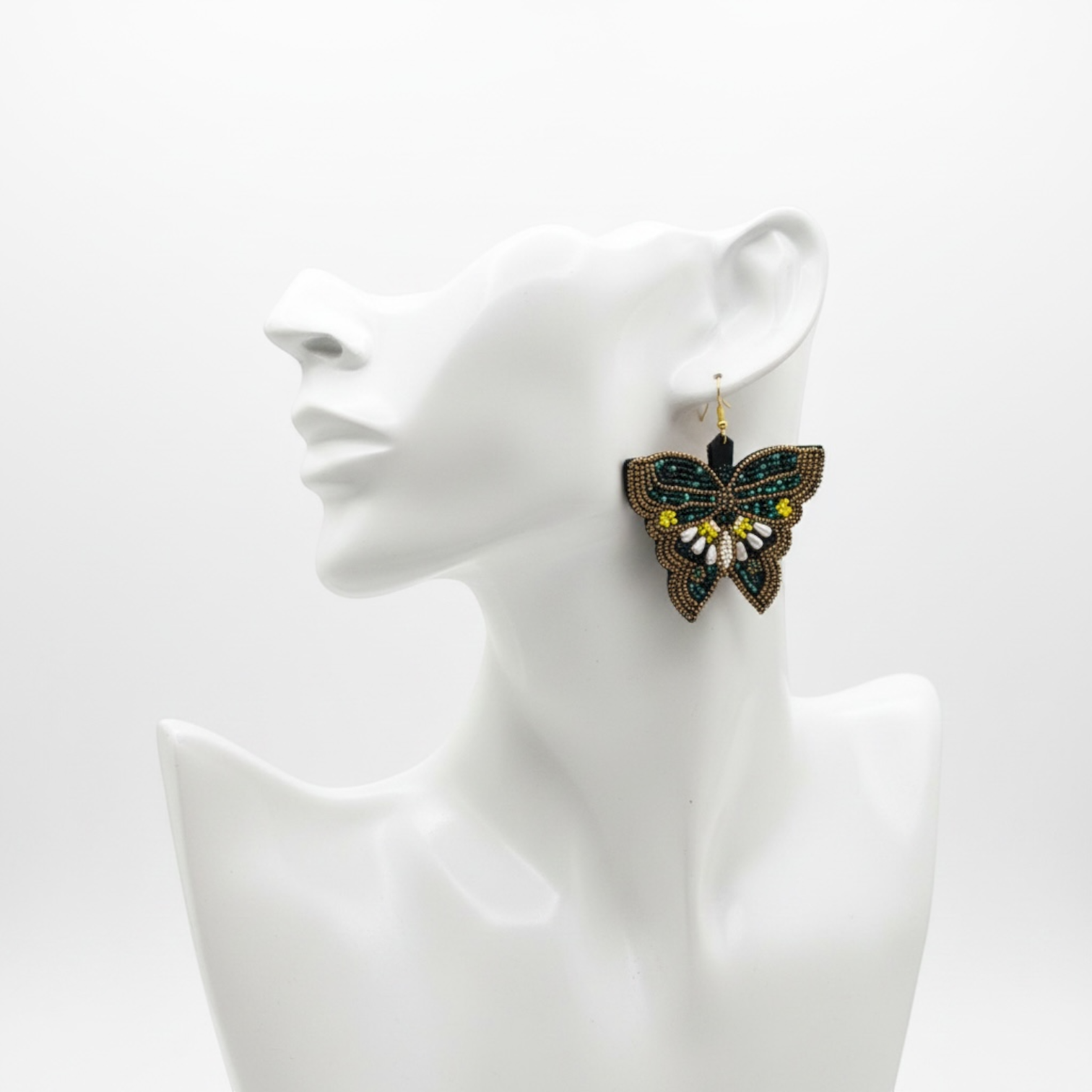 SEVEN SEVENTEEN Midnight Meadow butterfly earrings featuring intricate beadwork in dark green, gold, and white tones.